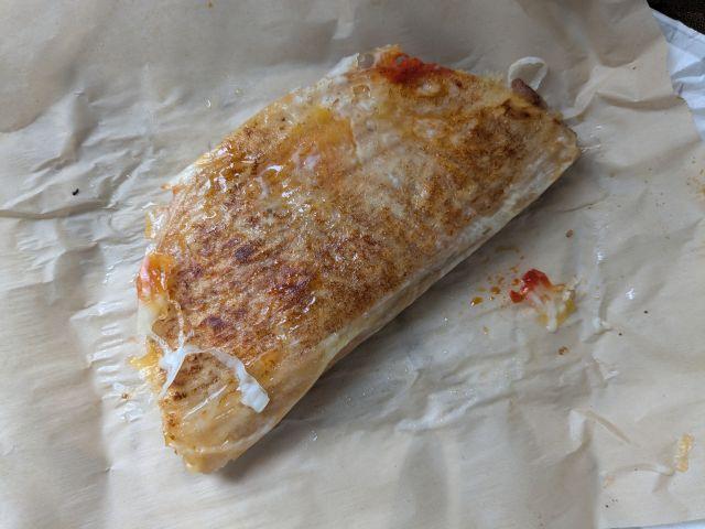The grilled cheese side of a Taco Bell Caliente Cantina Chicken Crispy Taco.