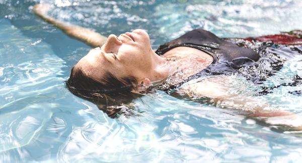 Woman Floats in Water | Benefits of Swimming