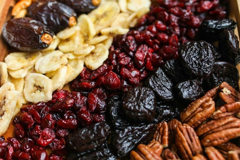 A selection of dried fruits and nuts arranged in a diagnoal stripe formation.
