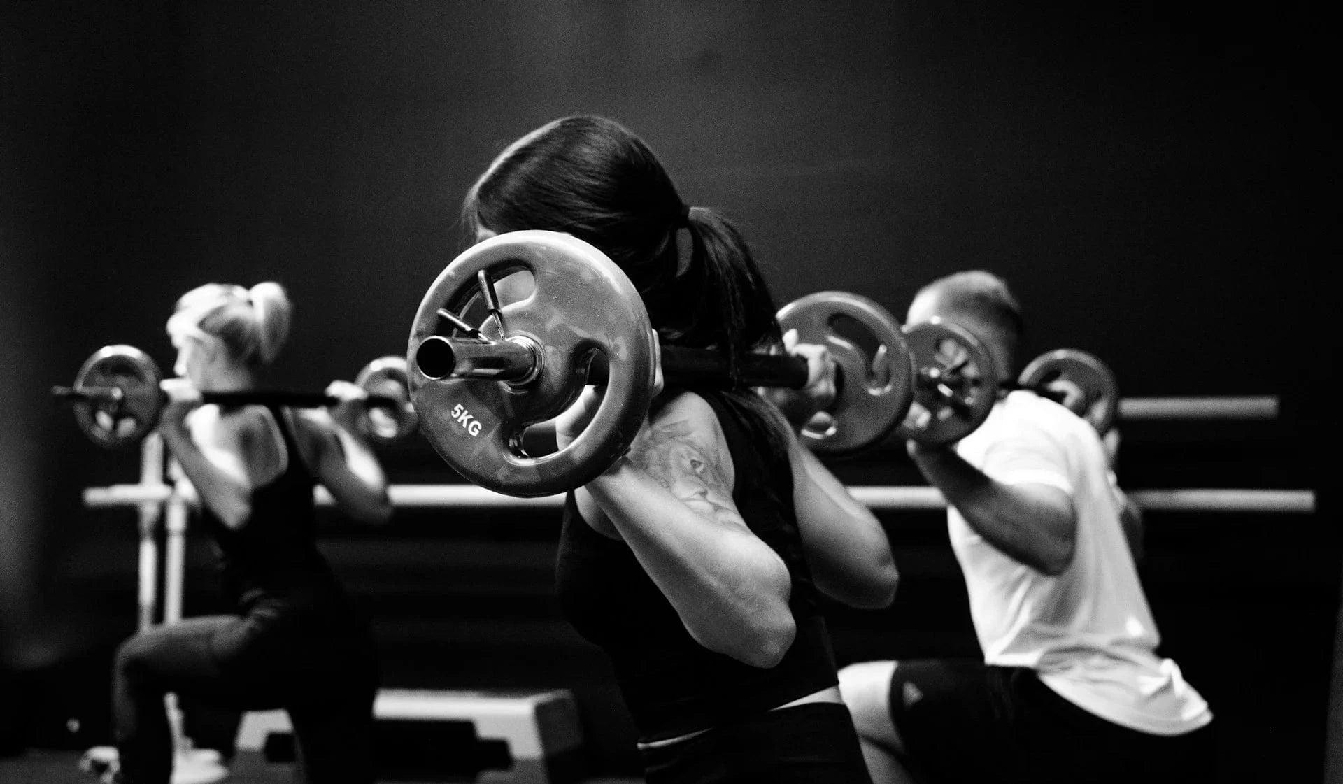 Women doing squats in a gym