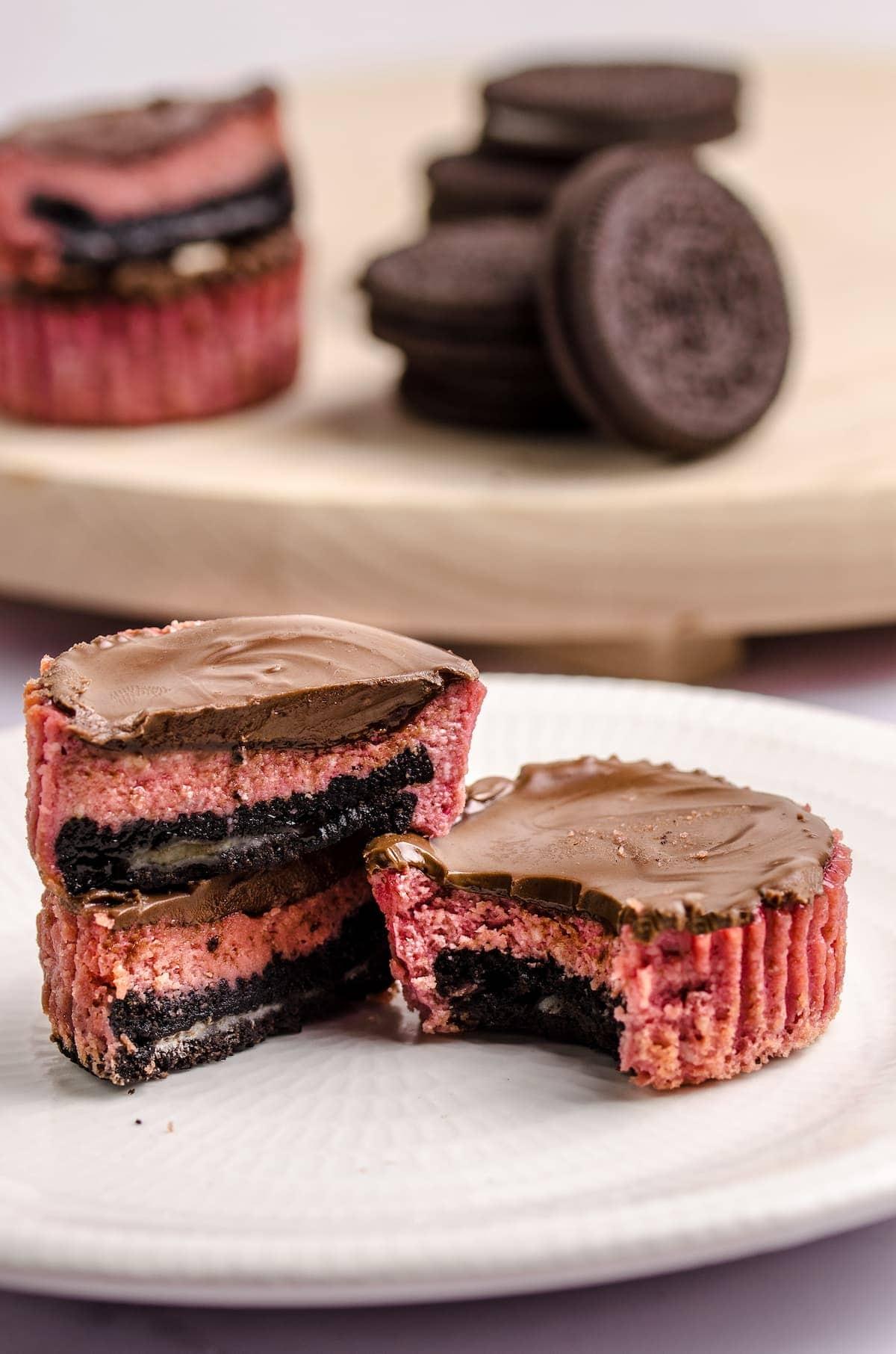 3 mini red velvet oreo cheesecakes on a plate