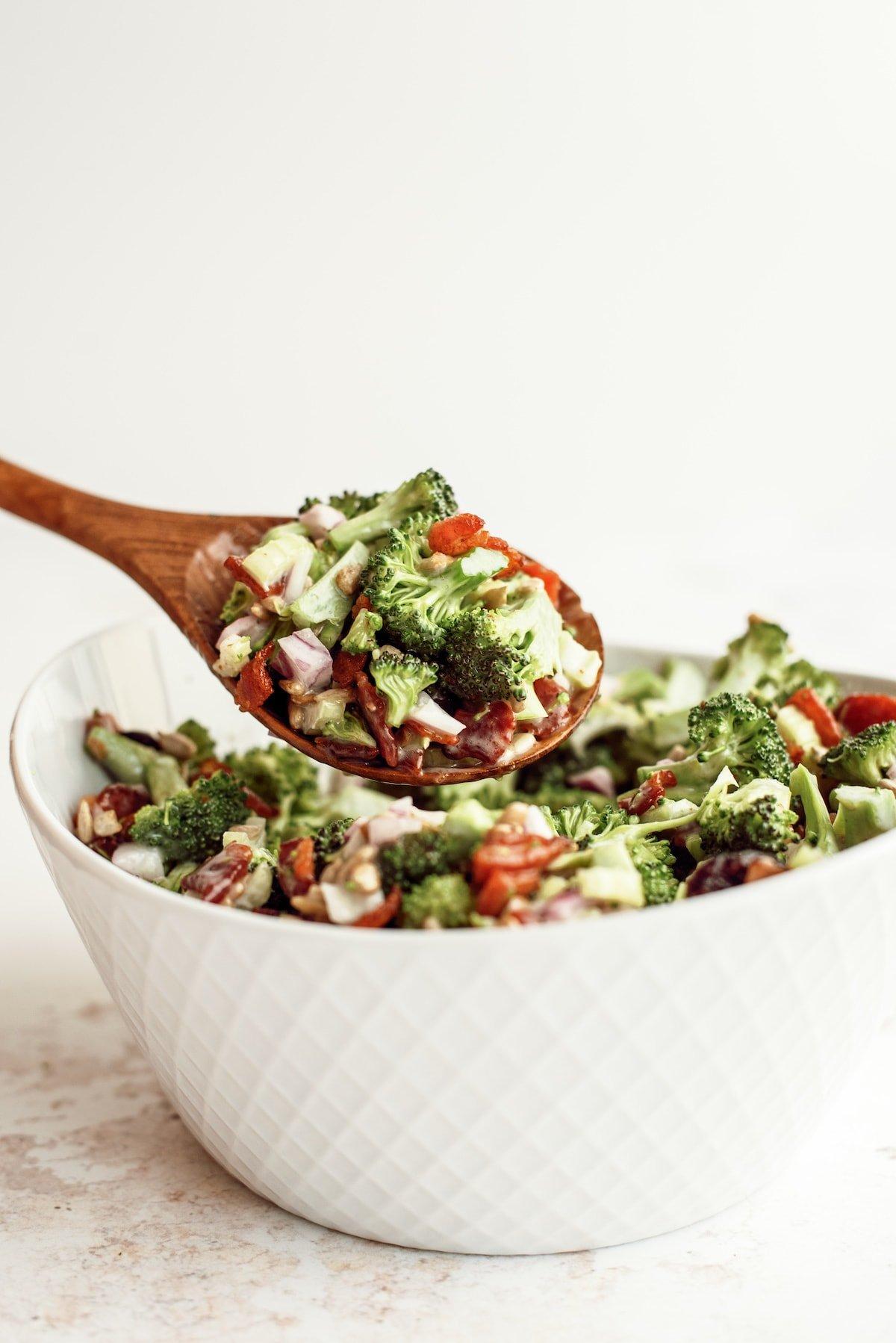 broccoli salad in a serving bowl with spoon