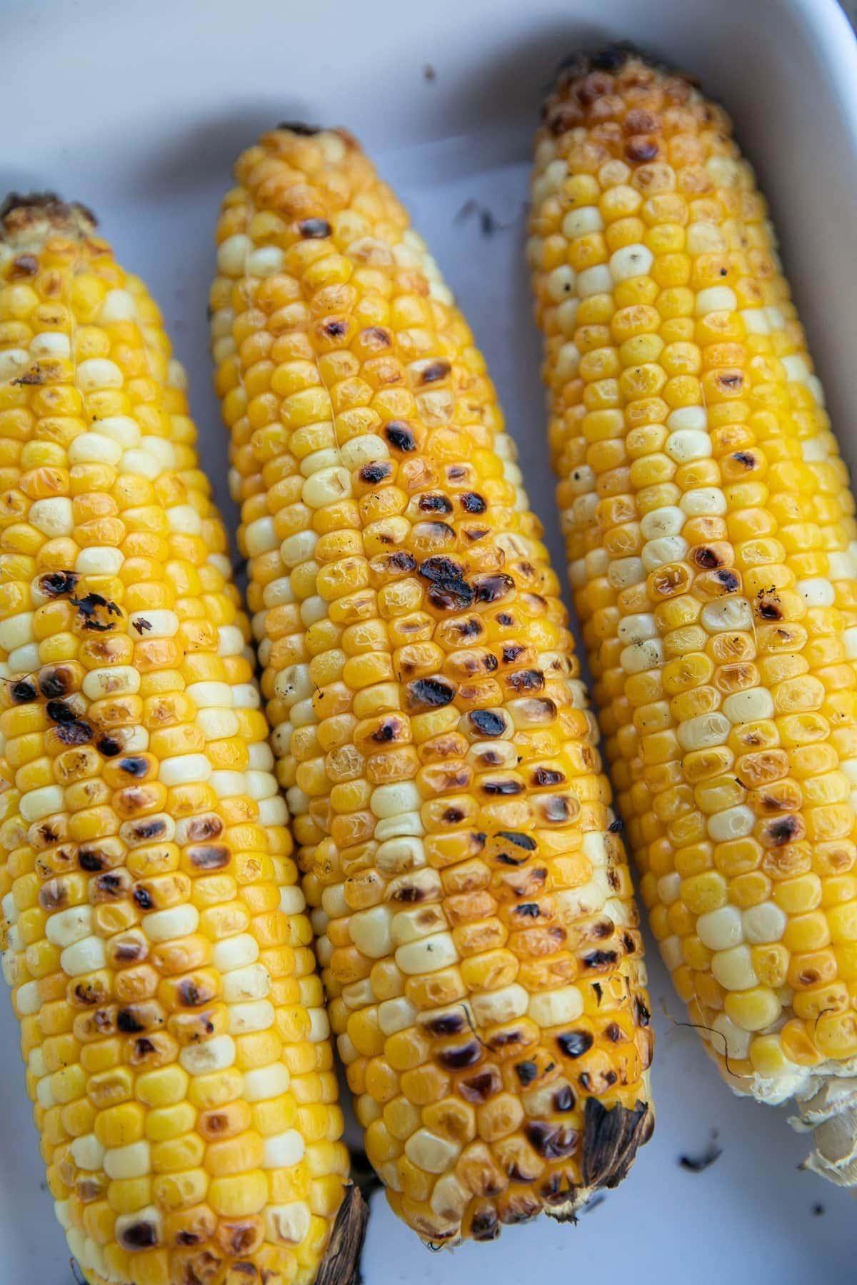 three ears of grilled corn