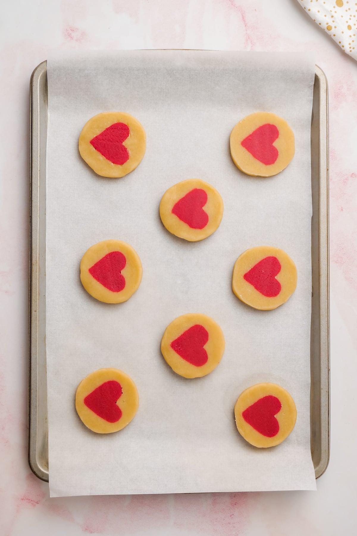 valentines day cookies 18 unbaked Valentine's Day cookies on baking sheet