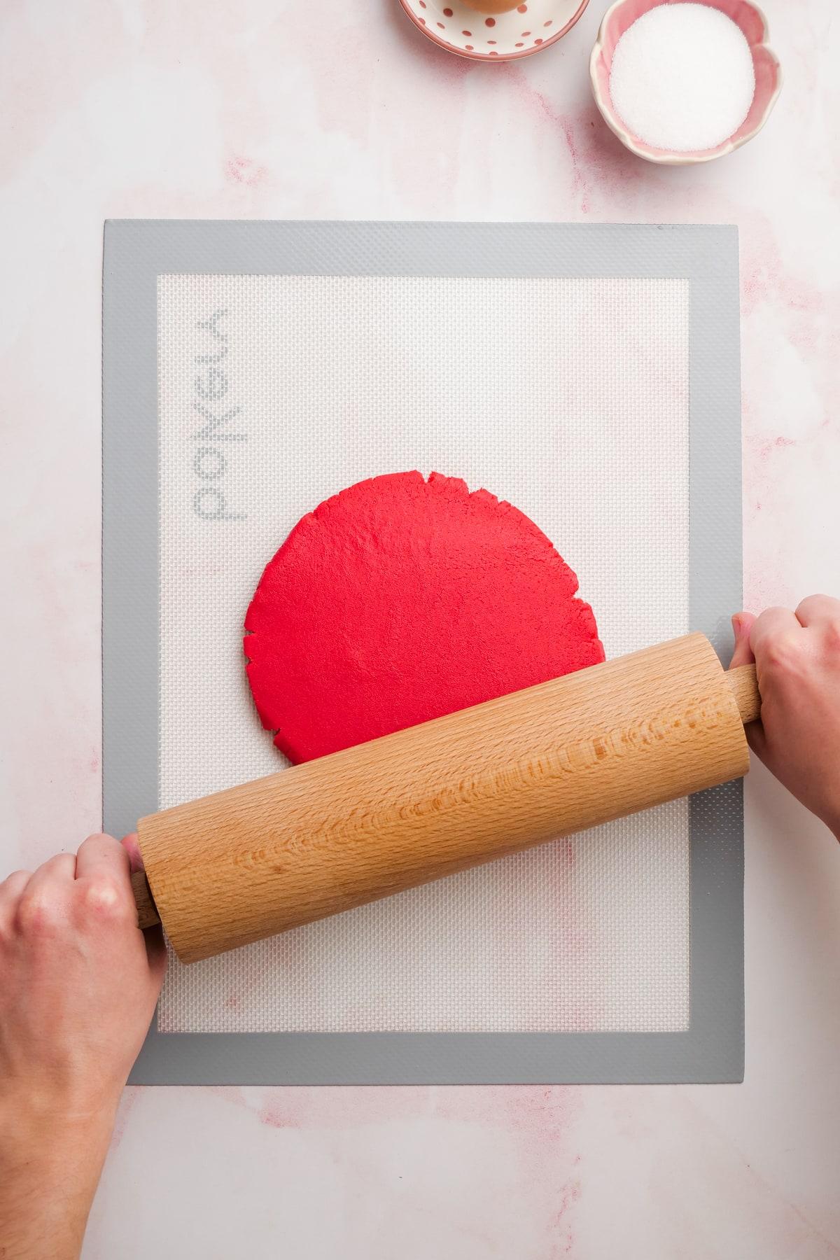 valentines day cookies 9 rolling out red cookie dough with rolling pin