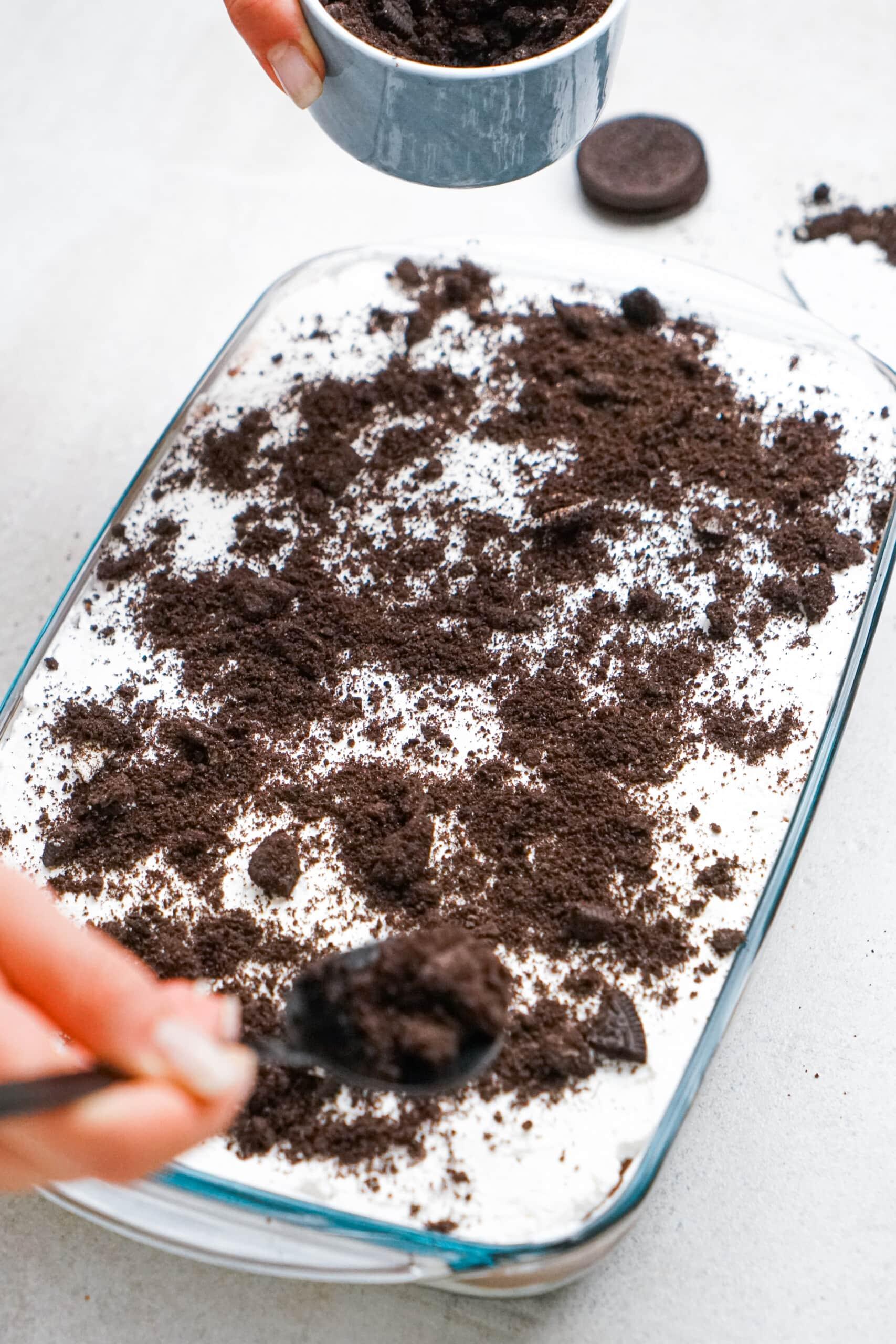oreo crumbs spread across chocolate lasagna