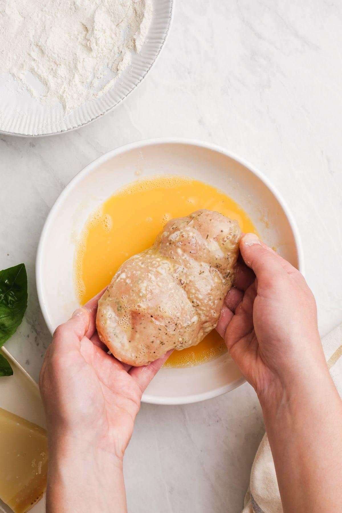 dredging chicken breast in egg