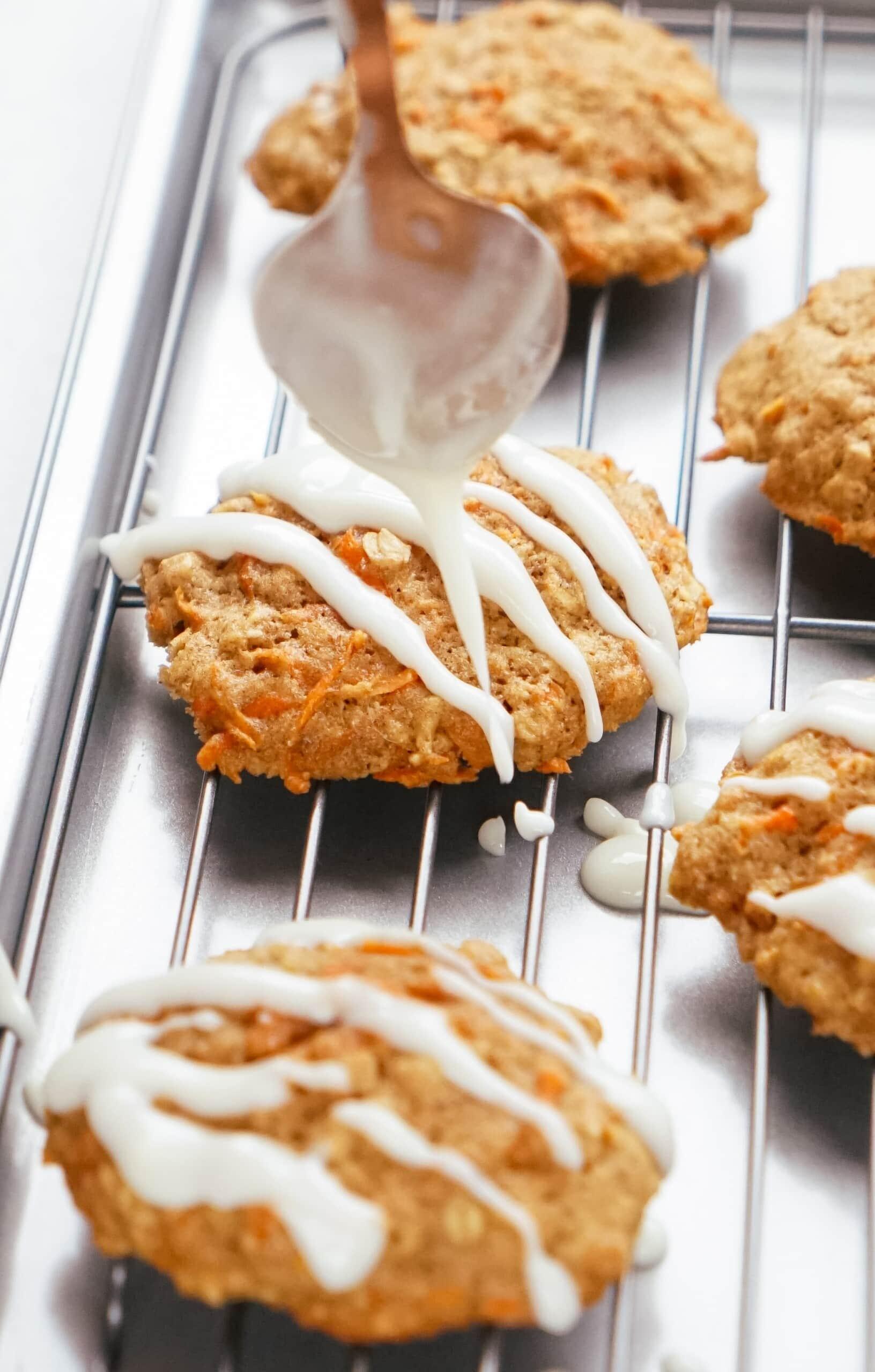 glaze being drizzled over warm cookies