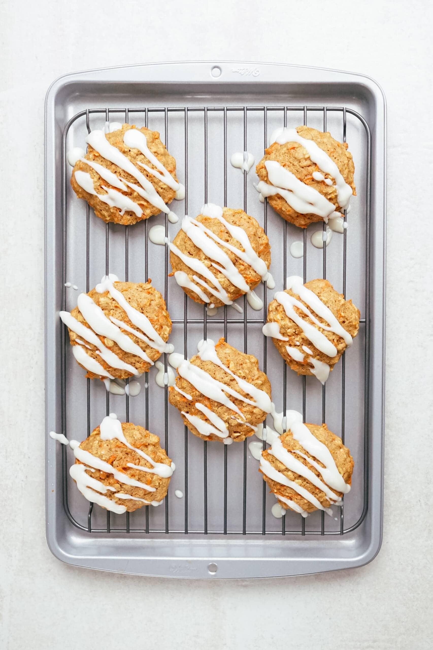 carrot oatmeal cookies on a cooling rack with glaze drizzled