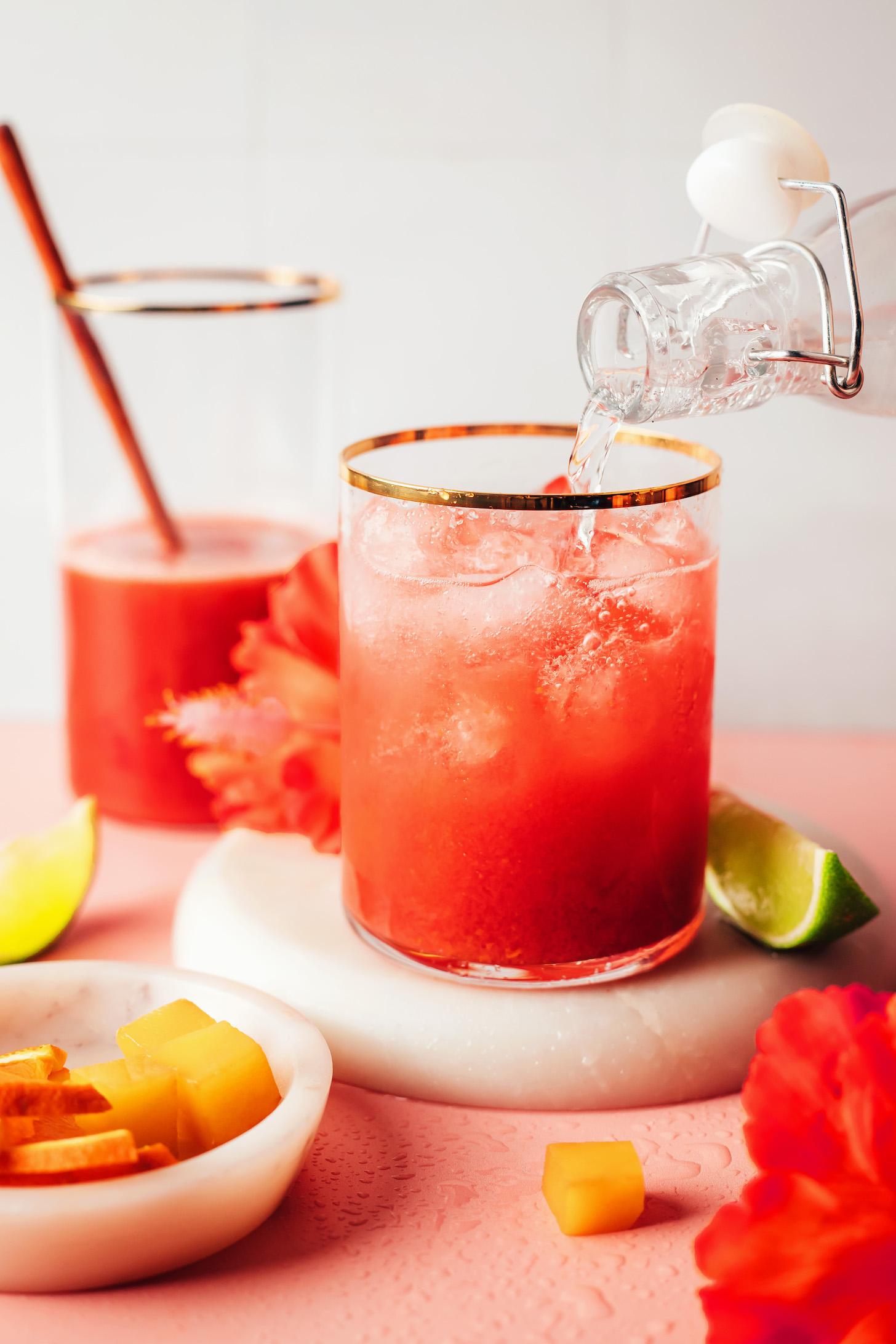 Pouring sparkling water into a glass to make a sparkling mocktail