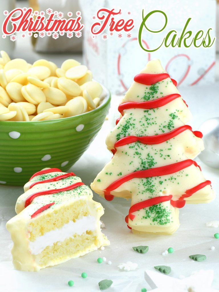 Whole Christmas tree cake and half cut of second piece in front of Christmas decorations.