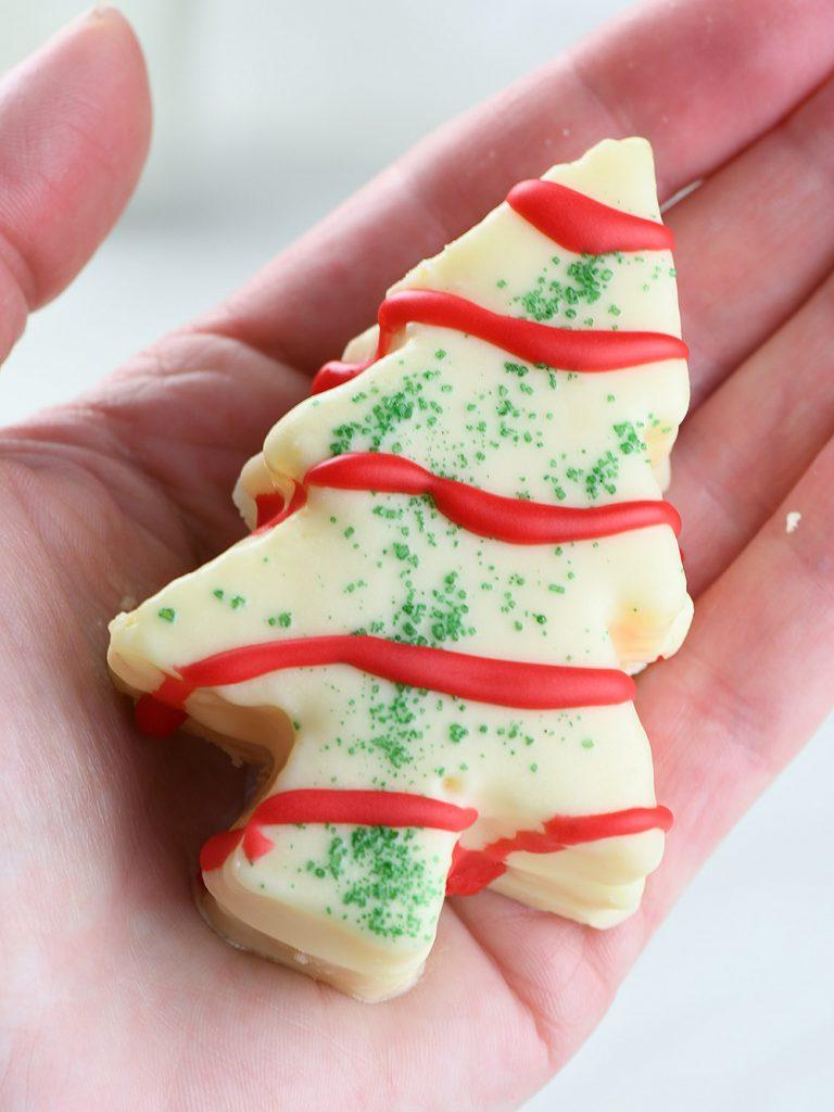 Piece of Homemade Christmas Tree Cake in hand.