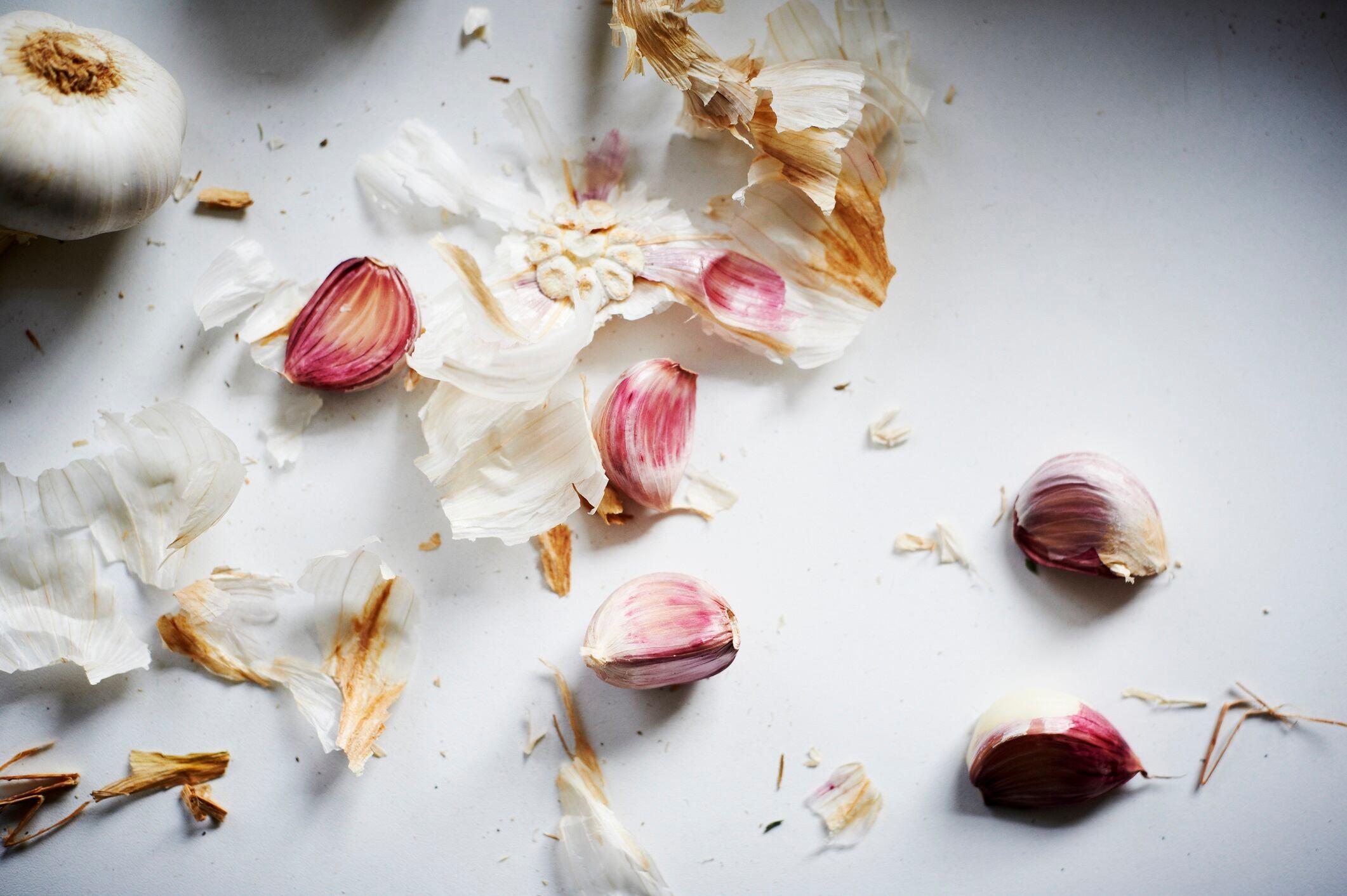 Garlic bulb and cloves on a white background.