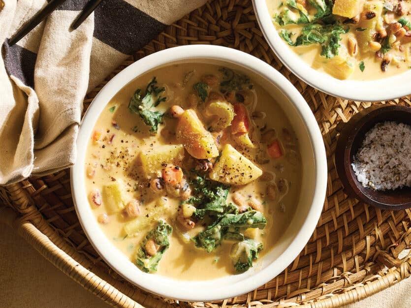 Two white serving bowls of Potato-Kale Black-Eyed Pea Soup