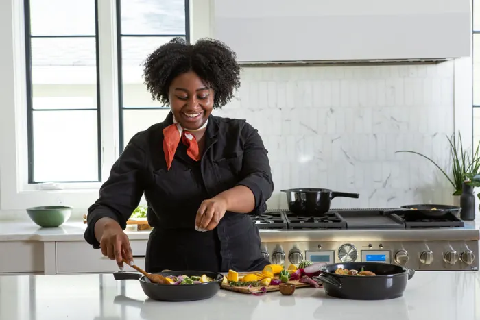 Image of Chef using Xtrema the best pure ceramic cookware safe cooking in a healthy kitchen. Xtrema cookware is one of the safest cookware brands on the market. Healthy, non-toxic cookware.