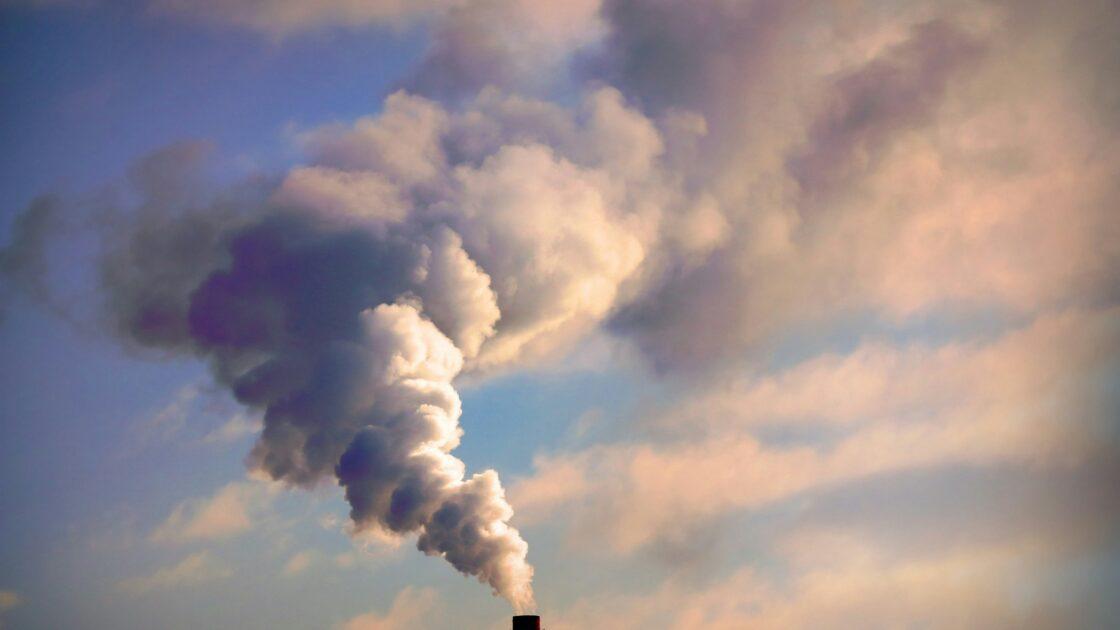 Image of a smoke stack with billowing smoke going into the air. the epa climate change ruling of 2009 is poised to be overturned.