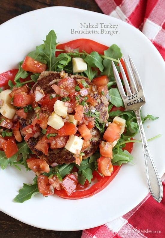 Naked Turkey Bruschetta Burger are healthy, delicious, turkey burgers made juicy thanks to added zucchini and topped with a summer garden tomato bruschetta topping over a bed of baby arugula – no bun required!